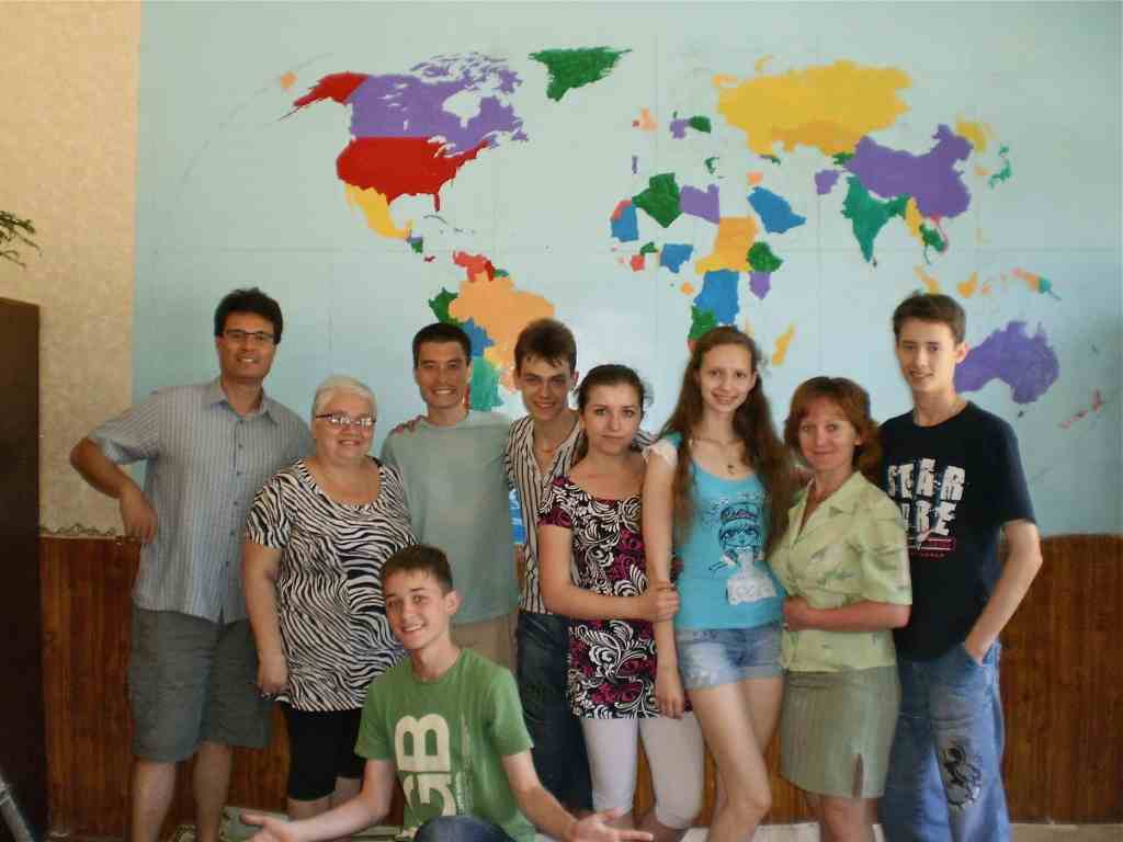 Me and my former Ukrainian students in front of a world map mural we painted.
